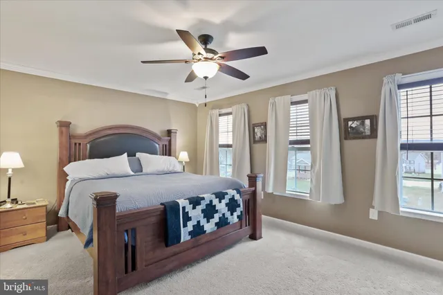 a bedroom with a large bed and a window