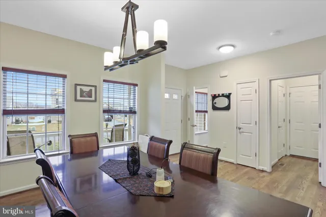 a living room with furniture wooden floor and a chandelier