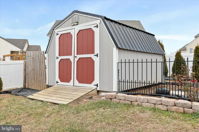 a view of a house with a wooden fence
