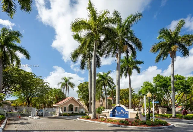 a view of the palm trees and a yard