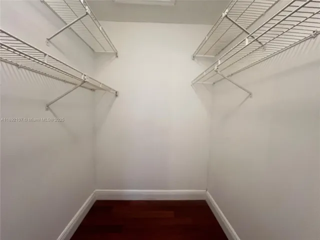 a bathroom with a granite countertop sink toilet mirror and shower