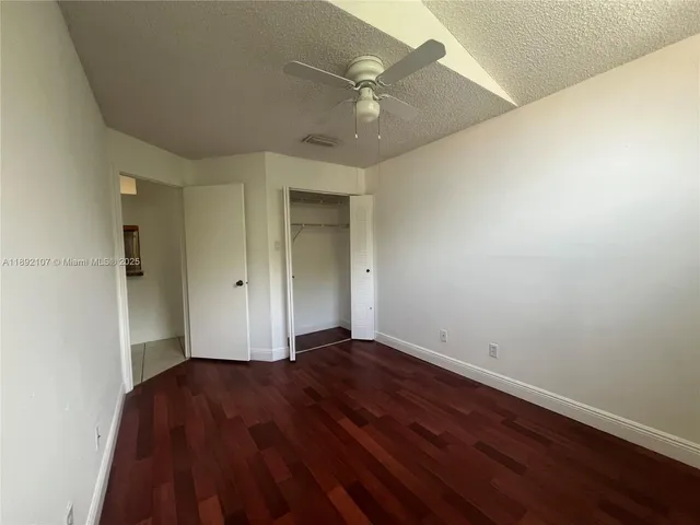 a view of a house with a yard and potted plants