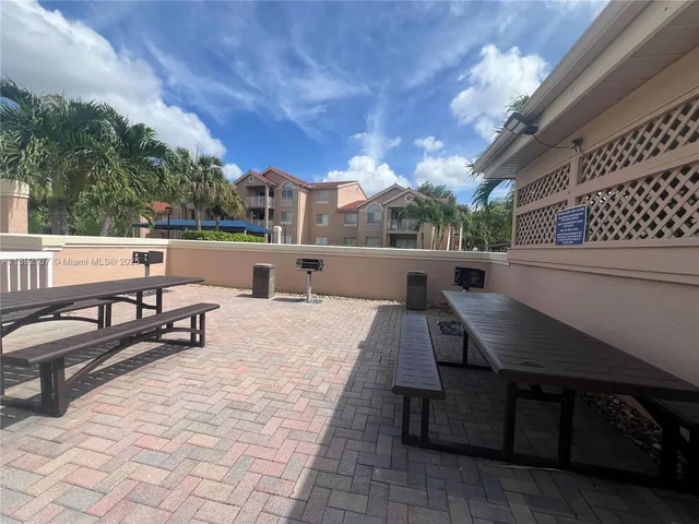 a view of a garden with a table under an umbrella