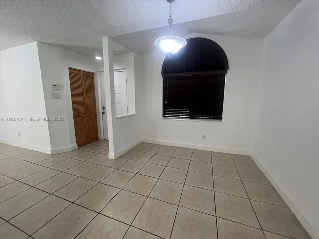 wooden floor in an empty room with a bathroom