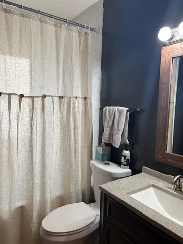 a bathroom with a sink toilet and a mirror