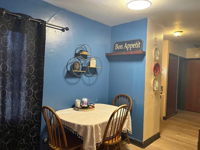 a view of a dining area with furniture and wooden floor