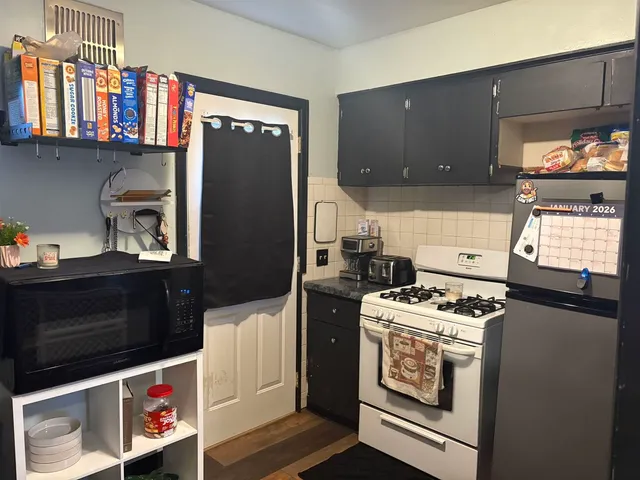 a kitchen with stainless steel appliances granite countertop a stove and a microwave