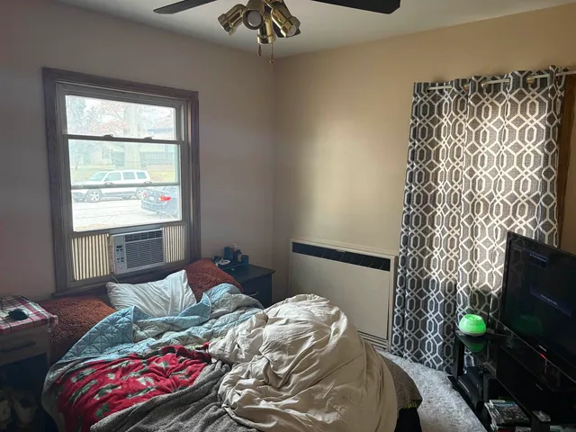 a bedroom with a bed and a window