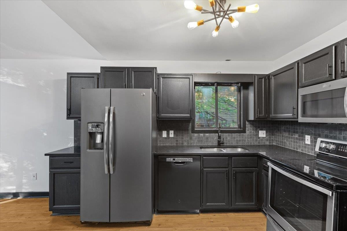 5433 Penrith Drive Durham, NC 27713 - Photo 12 of 47 a kitchen with a refrigerator sink and stove