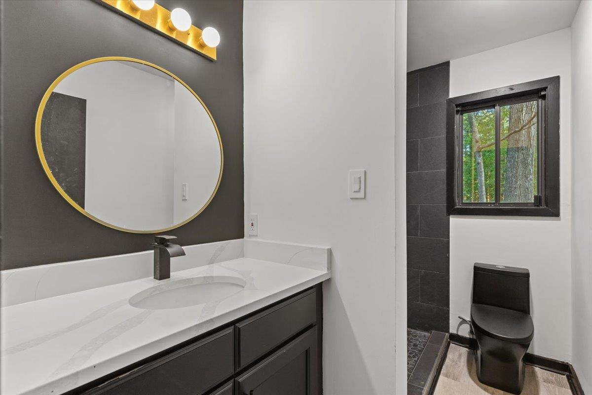 5433 Penrith Drive Durham, NC 27713 - Photo 16 of 47 a bathroom with a sink and a mirror