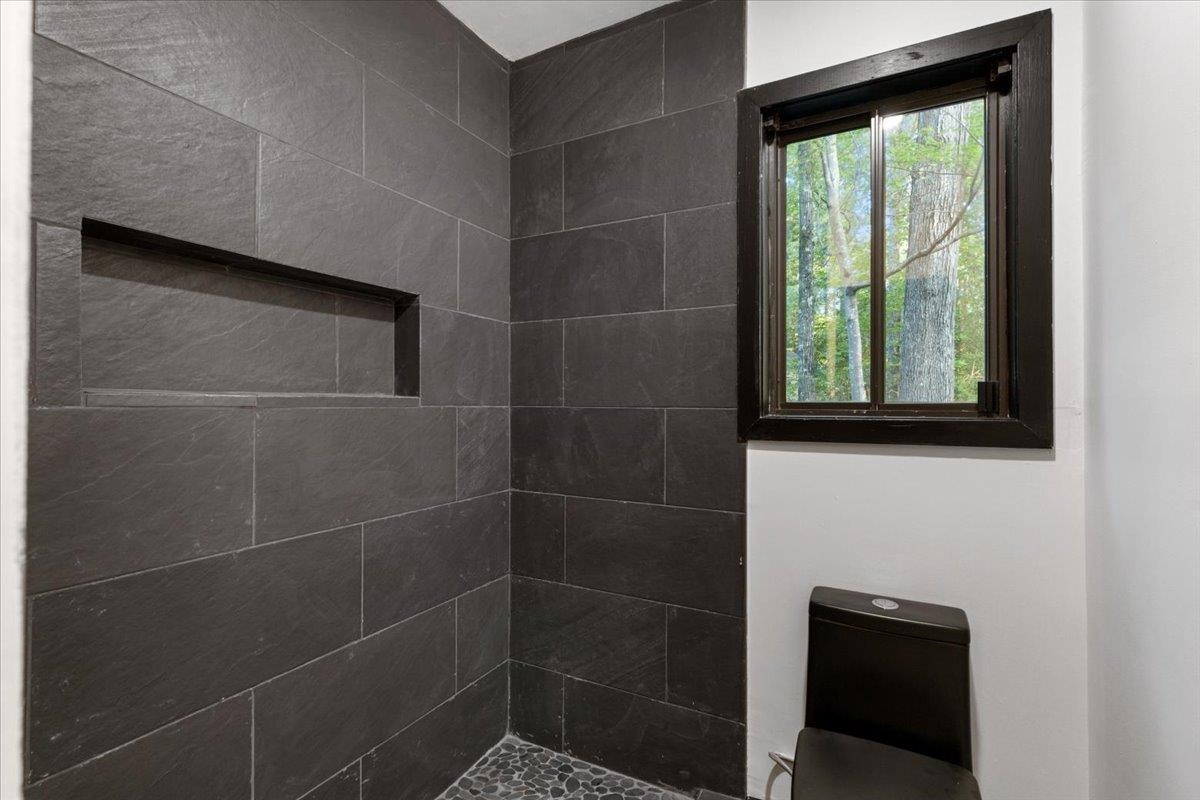 5433 Penrith Drive Durham, NC 27713 - Photo 17 of 47 a bathroom with a shower and a window