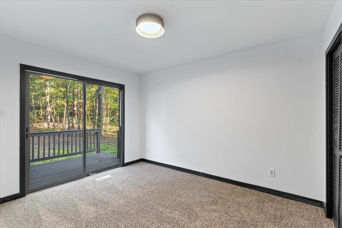5433 Penrith Drive Durham, NC 27713 - Photo 18 of 47 a view of a room with large windows