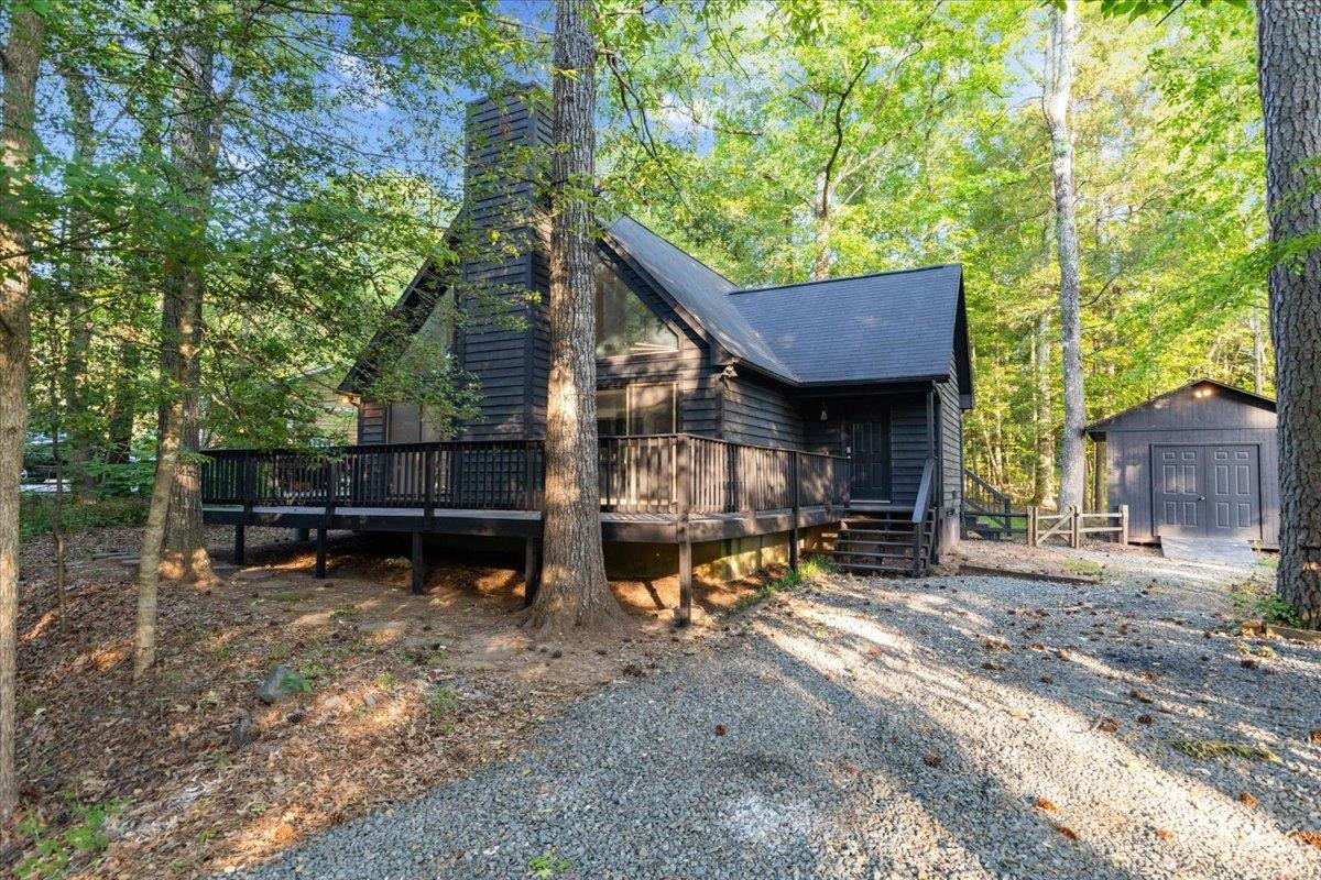 5433 Penrith Drive Durham, NC 27713 - Photo 2 of 47 a view of a wooden chairs and bench in a backyard