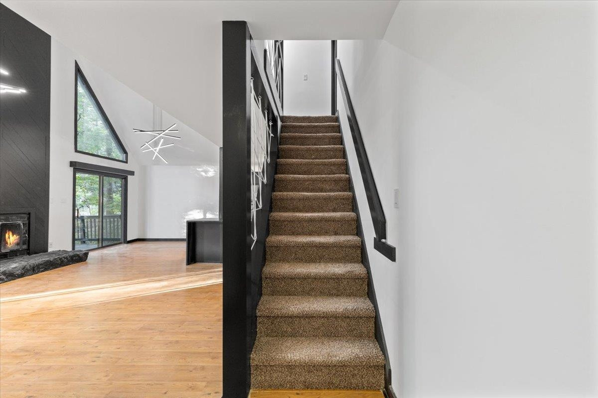 5433 Penrith Drive Durham, NC 27713 - Photo 21 of 47 a view of staircase with white walls and windows