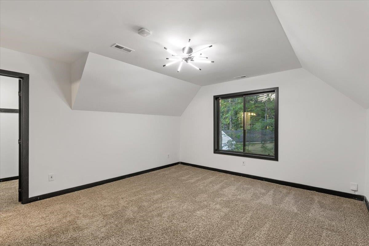 5433 Penrith Drive Durham, NC 27713 - Photo 30 of 47 an empty room with chandelier fan and windows