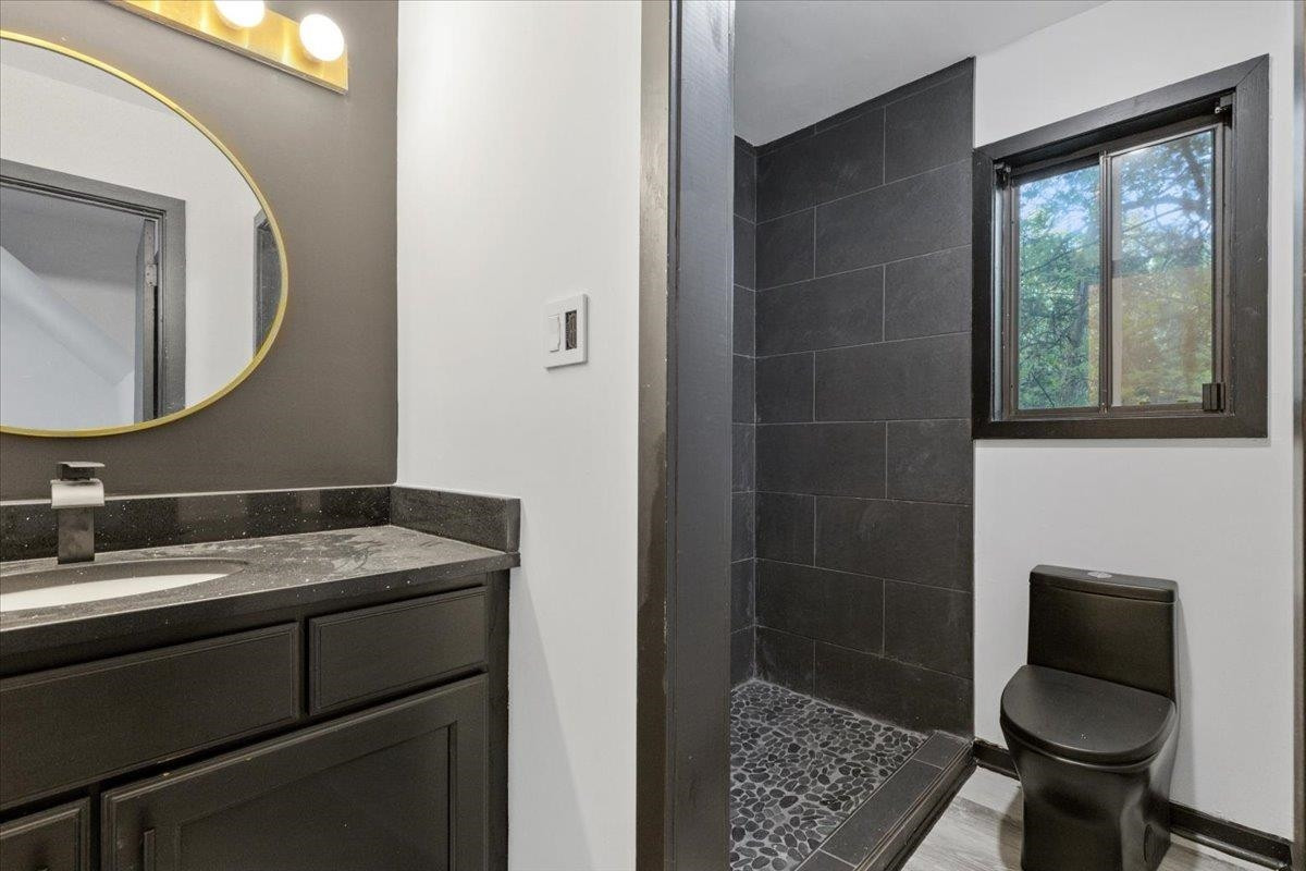 5433 Penrith Drive Durham, NC 27713 - Photo 33 of 47 a bathroom with a granite countertop sink toilet and mirror