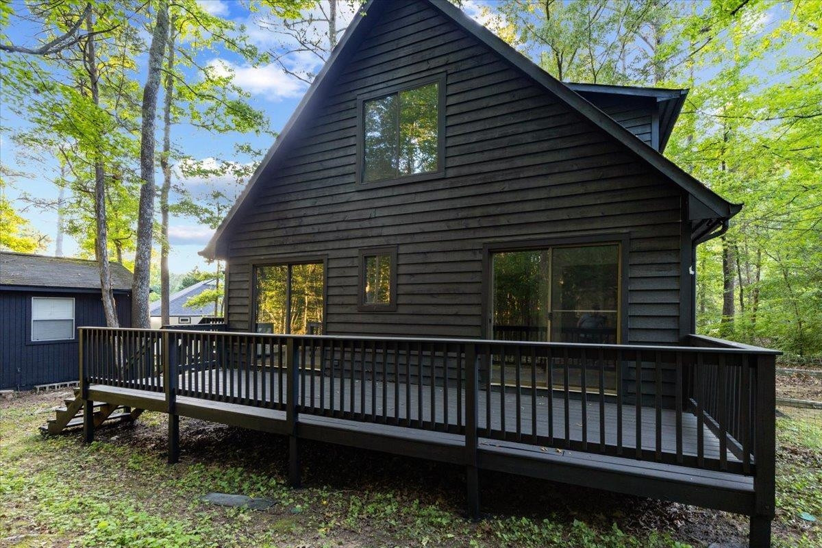 5433 Penrith Drive Durham, NC 27713 - Photo 42 of 47 a view of a house with a small deck and a yard