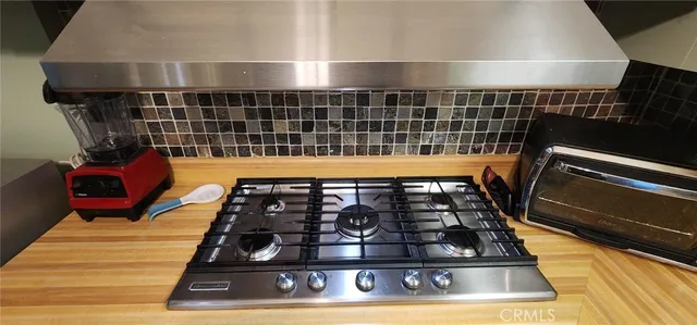 a kitchen with granite countertop a stove and a refrigerator