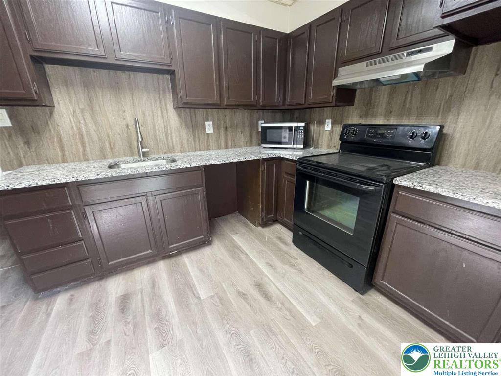 917 Center Street Bethlehem, PA 18018 - Photo 4 of 11 a kitchen with a sink stove and cabinets