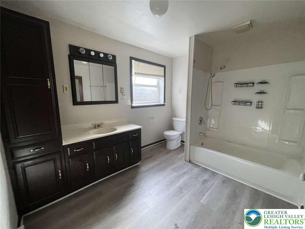 917 Center Street Bethlehem, PA 18018 - Photo 5 of 11 a bathroom with a double vanity sink a toilet and shower
