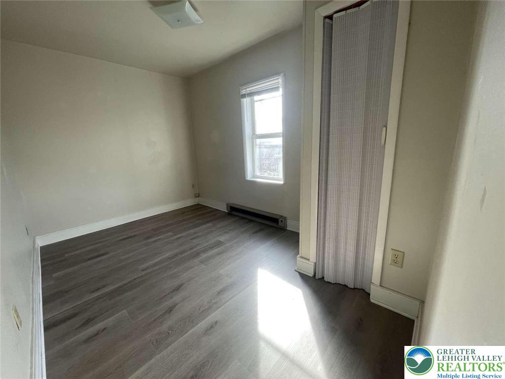 917 Center Street Bethlehem, PA 18018 - Photo 7 of 11 an empty room with wooden floor and windows