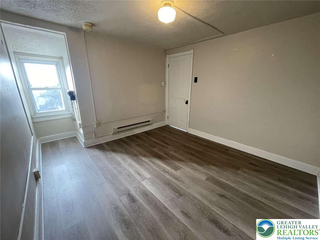 917 Center Street Bethlehem, PA 18018 - Photo 10 of 11 a view of an empty room with wooden floor and a window