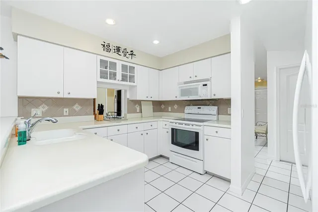 a dining room with wooden floor a chandelier a wooden table and chairs