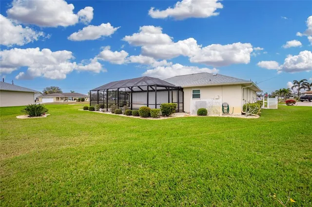 a view of a house with a backyard