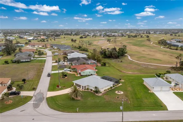 an aerial view of a house with a yard
