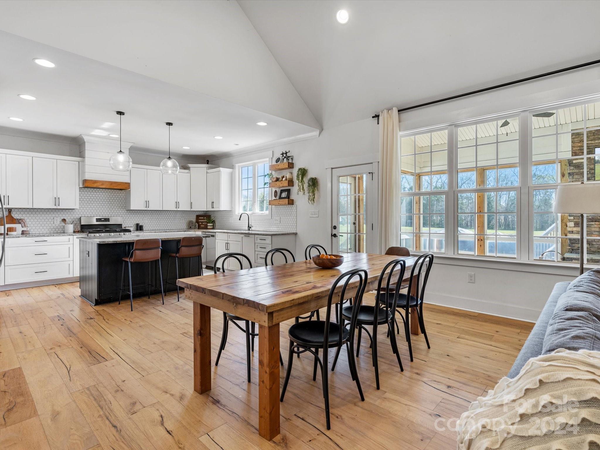 4078 Booney Road Rock Hill, SC 29730 - Photo 12 of 41 a kitchen with stainless steel appliances granite countertop a table chairs sink and cabinets