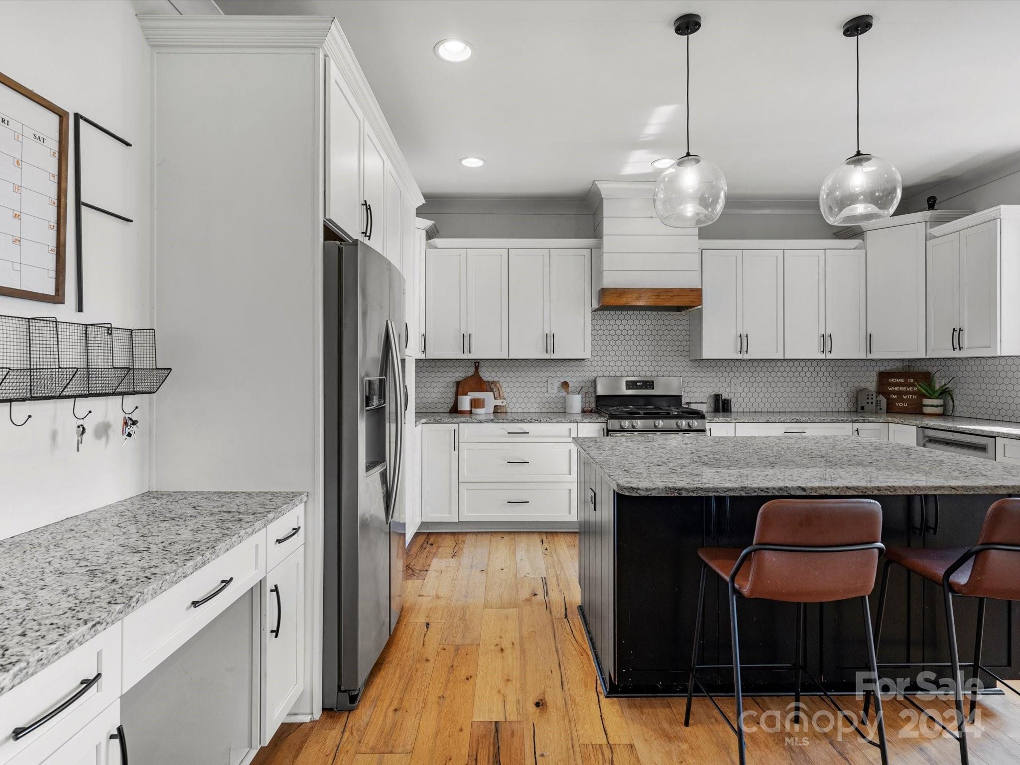 4078 Booney Road Rock Hill, SC 29730 - Photo 16 of 41 a large kitchen with granite countertop a white stove top oven a sink dishwasher and a refrigerator with wooden floor