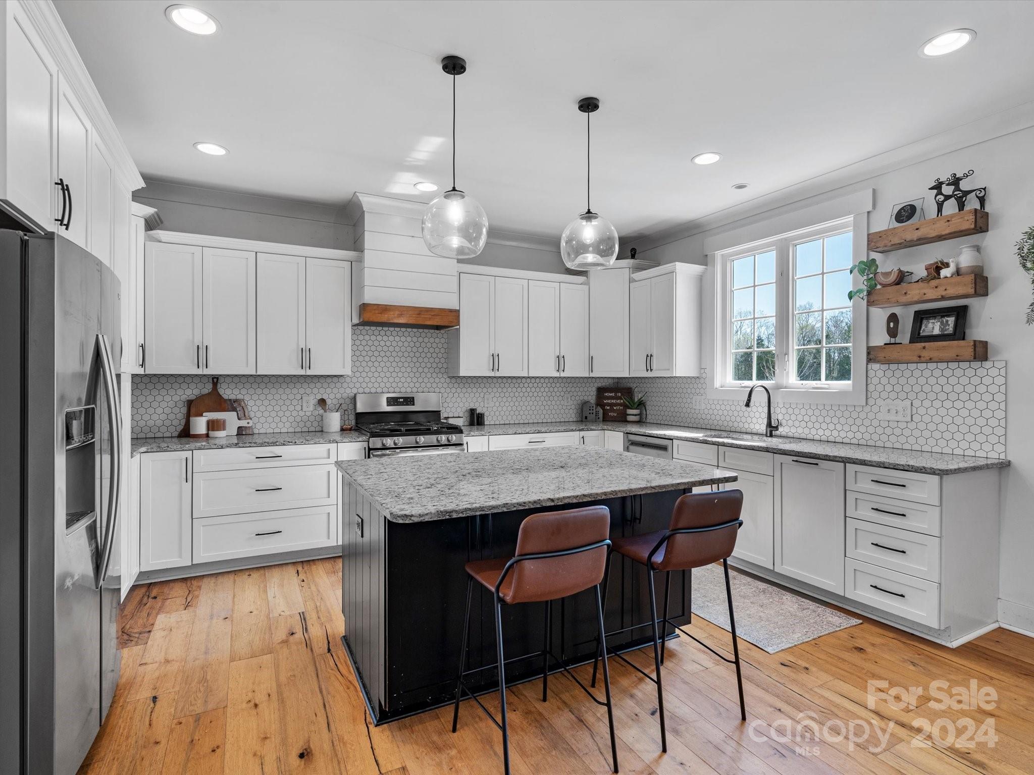 4078 Booney Road Rock Hill, SC 29730 - Photo 18 of 41 a kitchen with kitchen island granite countertop a sink a center island and cabinets