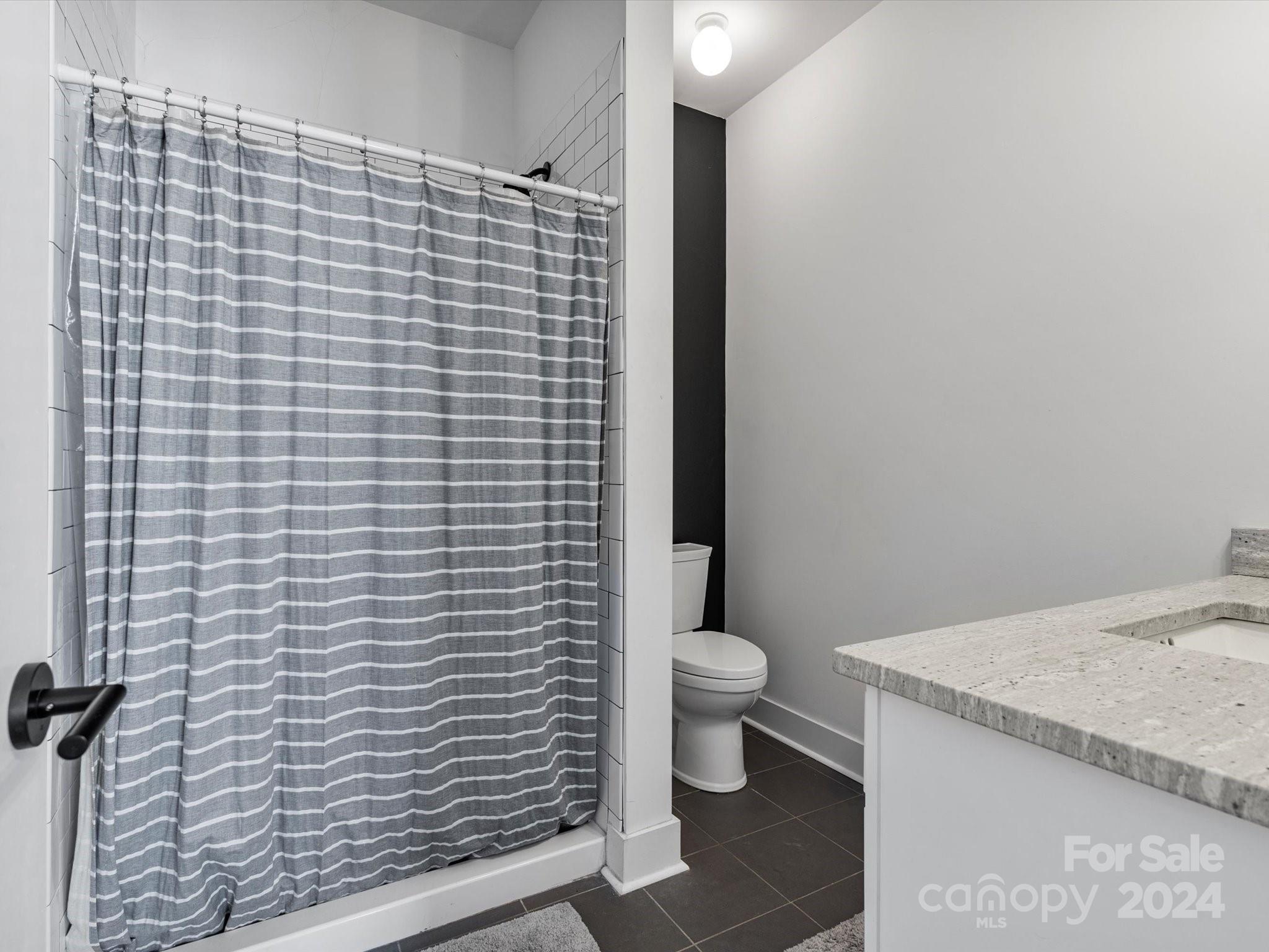 4078 Booney Road Rock Hill, SC 29730 - Photo 22 of 41 a bathroom with a granite countertop toilet and sink