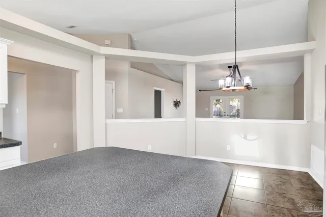 a view of a room with a window and chandelier