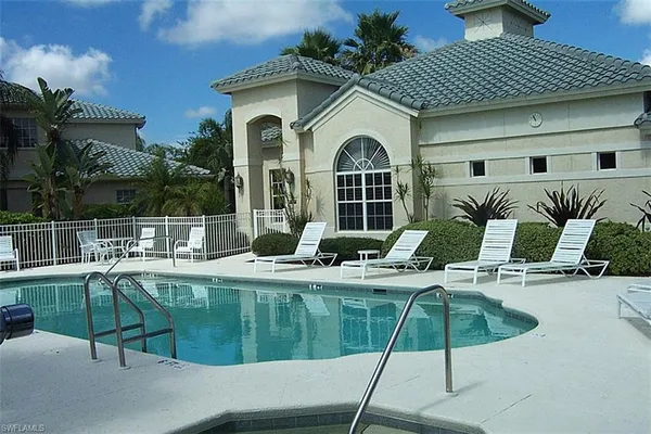 a view of house with swimming pool outdoor seating