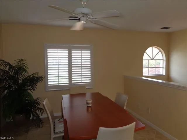 a view of a dining room with furniture and a window