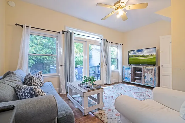 a living room with furniture and a flat screen tv
