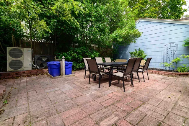 a view of a patio with table and chairs and potted plants
