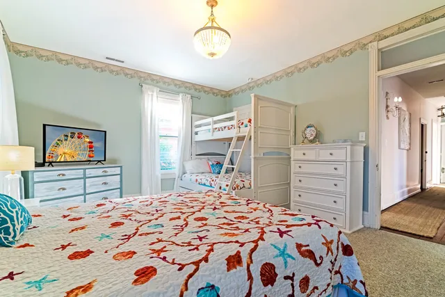 a bedroom with a bed and a dresser in it