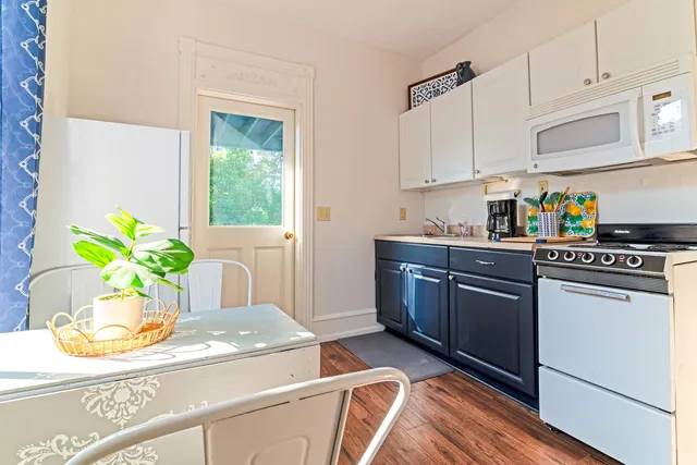 a kitchen with stainless steel appliances granite countertop a refrigerator a stove a sink a counter space and cabinets