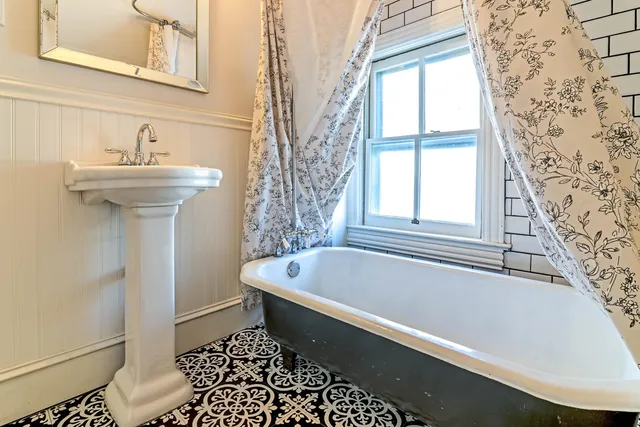 a bathroom with a toilet and a shower curtain