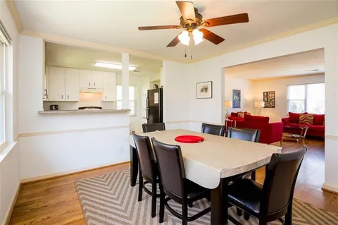 a view of a dining room with furniture and wooden floor