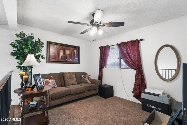 a living room with furniture a chandelier and a mirror