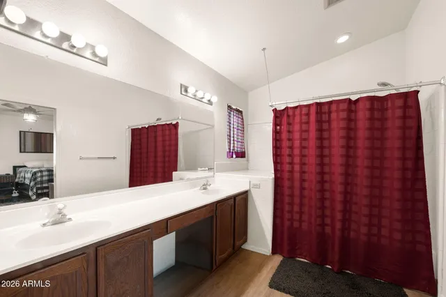 a bathroom with double vanity and a mirror