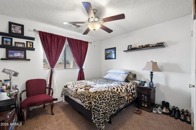 a bedroom with a bed a couch and a window