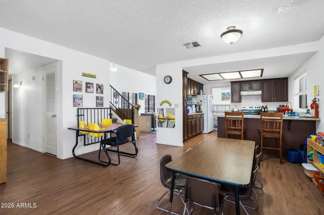 a living room with furniture and kitchen view