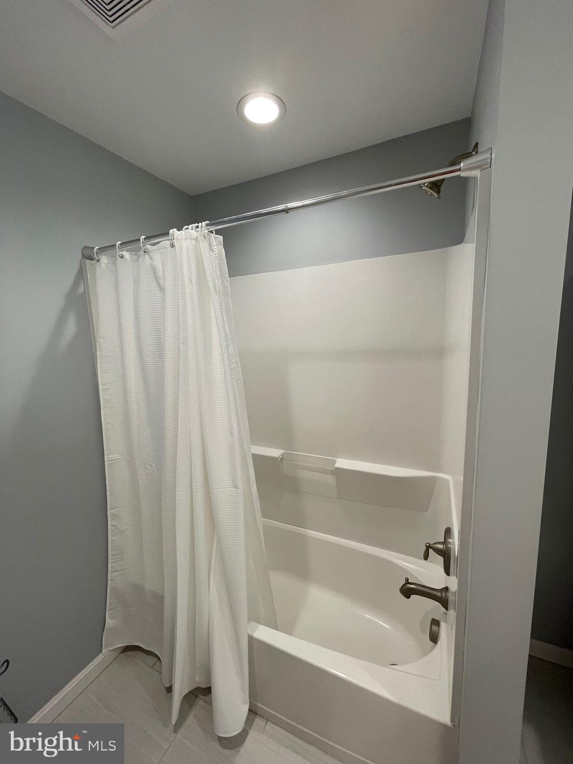 44600 Tall Timbers Road, Unit A Tall Timbers, MD 20690 - Photo 11 of 20 a bathroom with a shower and a bath tub
