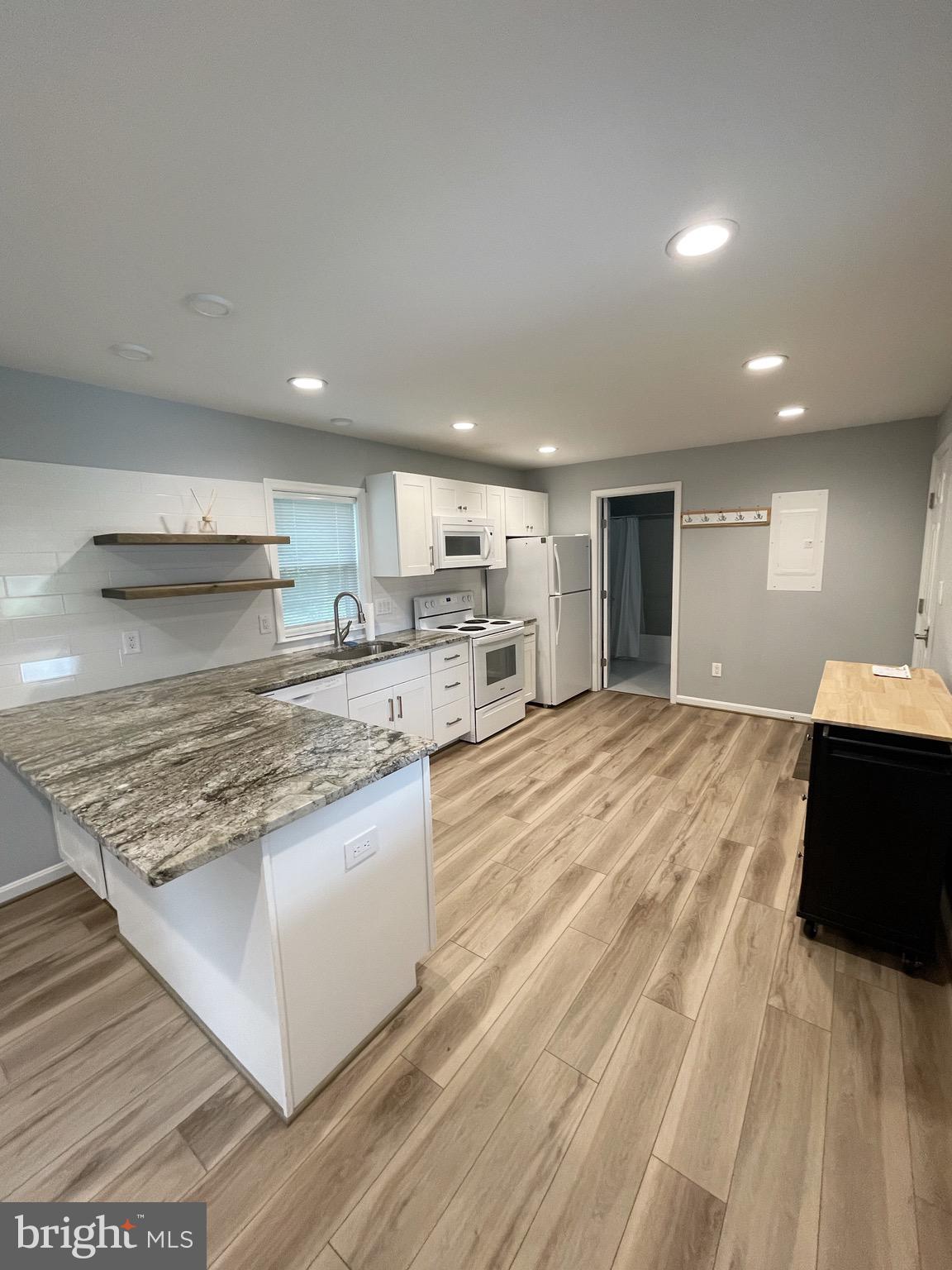 44600 Tall Timbers Road, Unit A Tall Timbers, MD 20690 - Photo 5 of 20 a large kitchen with kitchen island a stove a sink dishwasher and a oven with large countertops