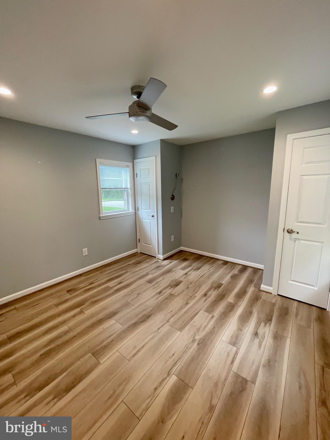 44600 Tall Timbers Road, Unit A Tall Timbers, MD 20690 - Photo 7 of 20 a view of empty room with wooden floor and fan