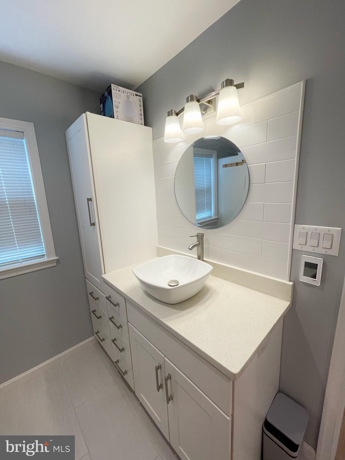 44600 Tall Timbers Road, Unit A Tall Timbers, MD 20690 - Photo 8 of 20 a bathroom with a sink mirror and vanity